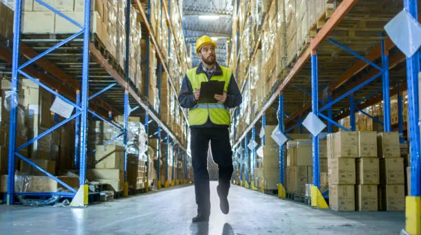 someone checking stock in a warehouse